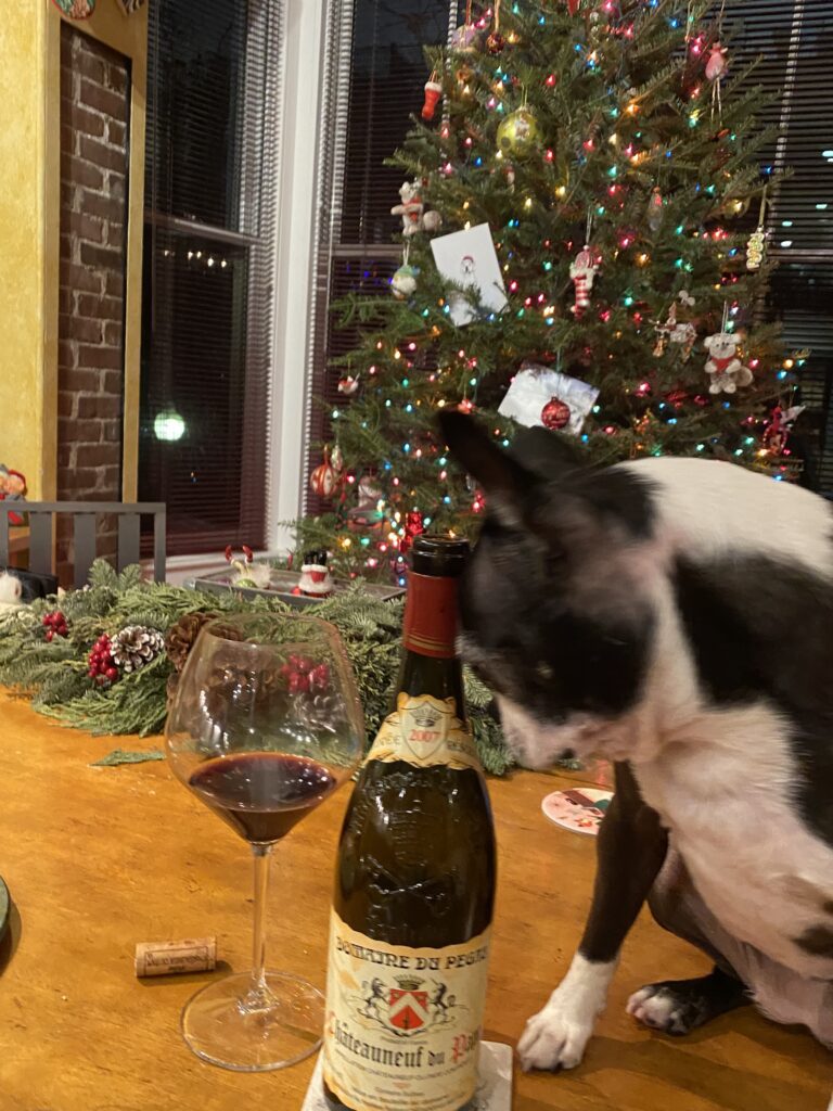 A dog pushing a wine bottle, southern france wine Château Pégau 2016 "Cuvée  Maclura” Côtes  Du Rhône  Rouge